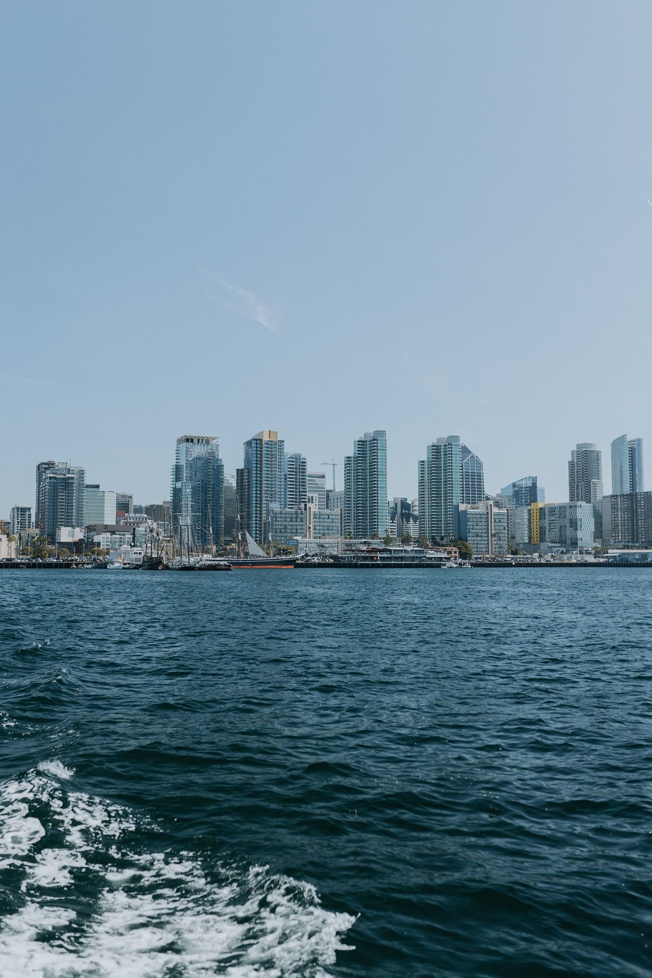 Panoramic view of San Diego's downtown skyline and waterfront seen from a boat deck.