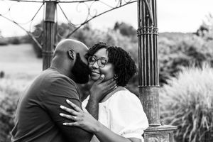 A romantic couple sharing tender moments in a series of black and white photographs in a park setting.