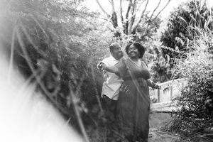 A black and white photo series showing people playing and having fun outdoors in a natural setting.