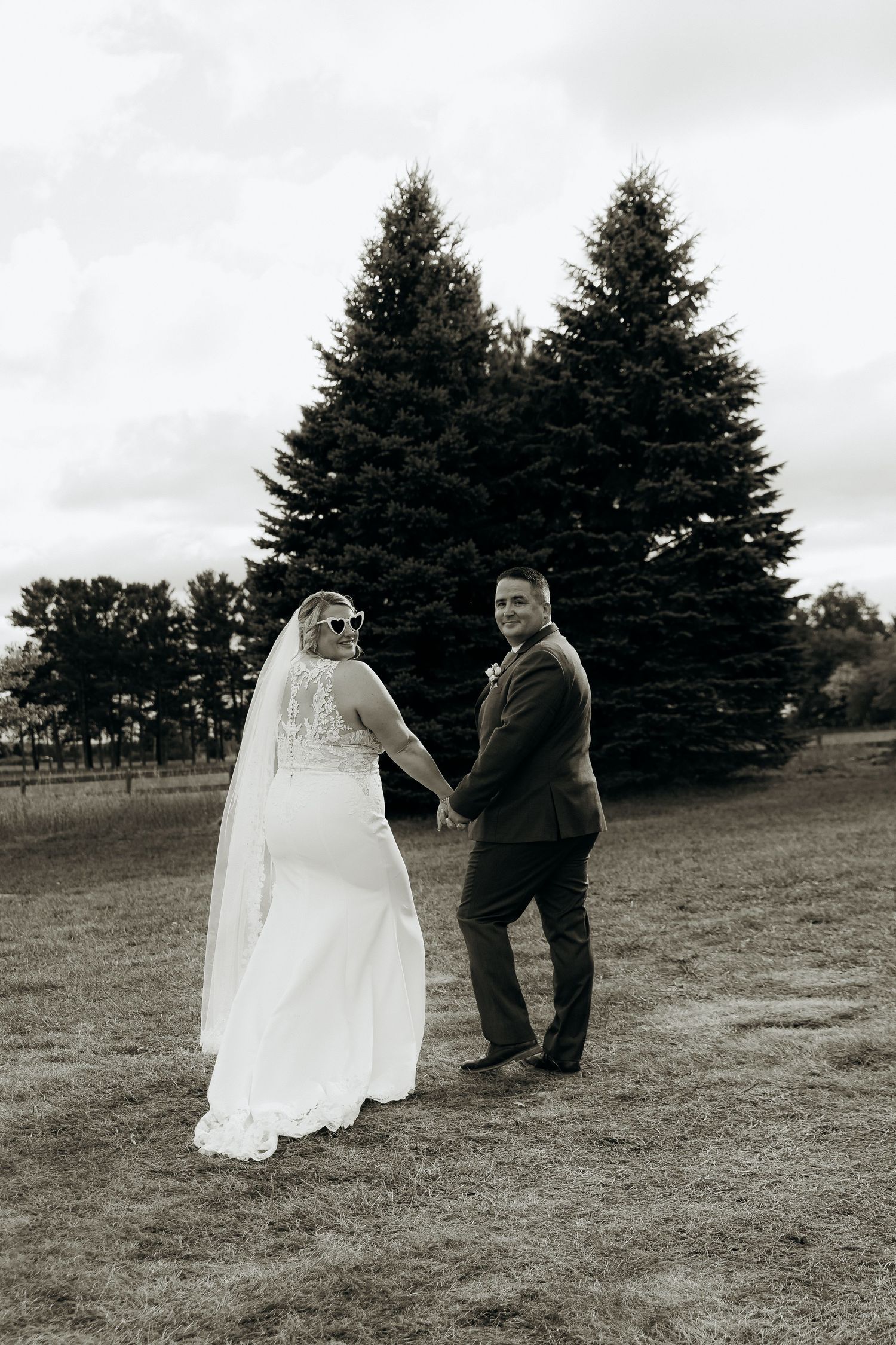A series of five photos showing a white wedding dress swaying against a window with beige curtains and wooden railings.