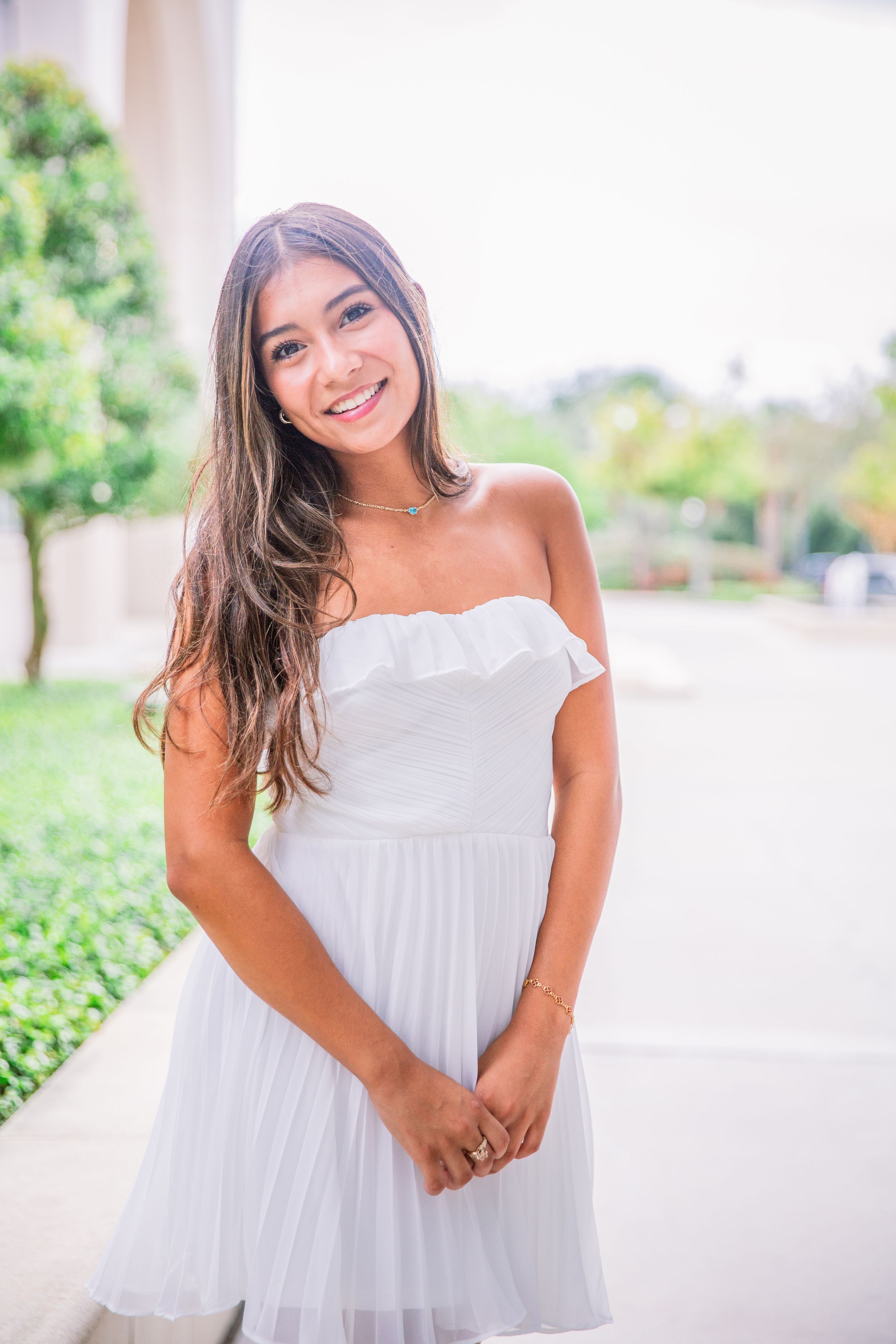 A series of outdoor portraits showing someone in a flowing white summer dress against a bright natural background.
