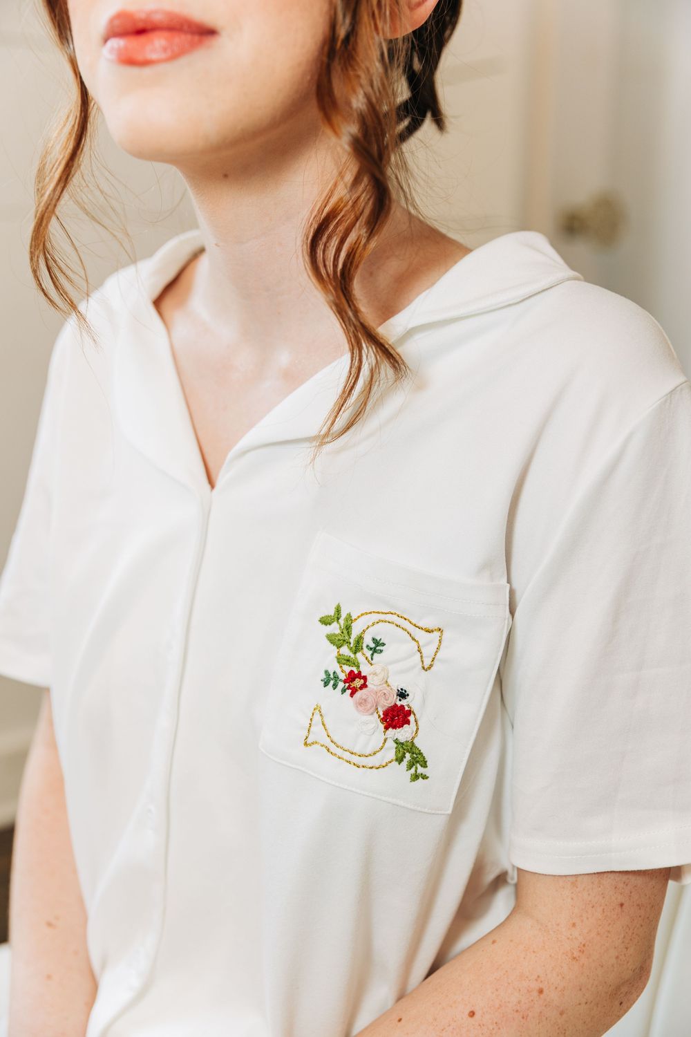 White collared shirt with delicate floral embroidery detail shown in a series of close-up product photos.