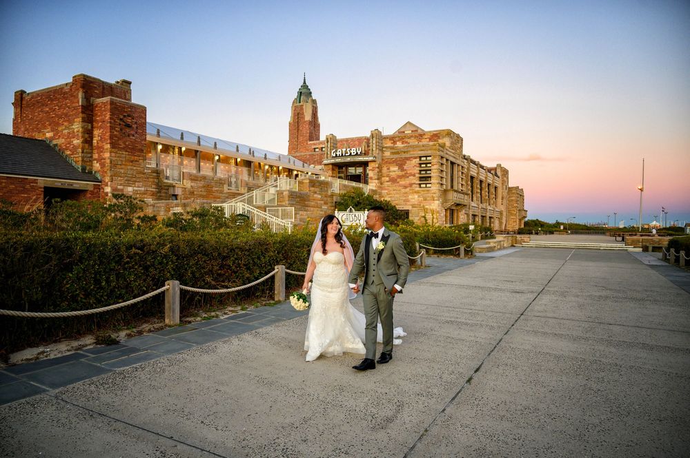 At GatsbyJones Beach, Long Island, the bride and groom were photographed by Deja Vu Studios at sunset.