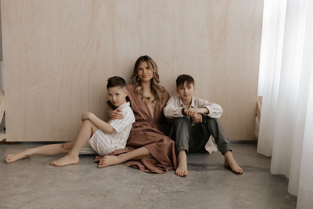 a mom and her young boys pose for a mothers day shoot in a studio in calgary alberta