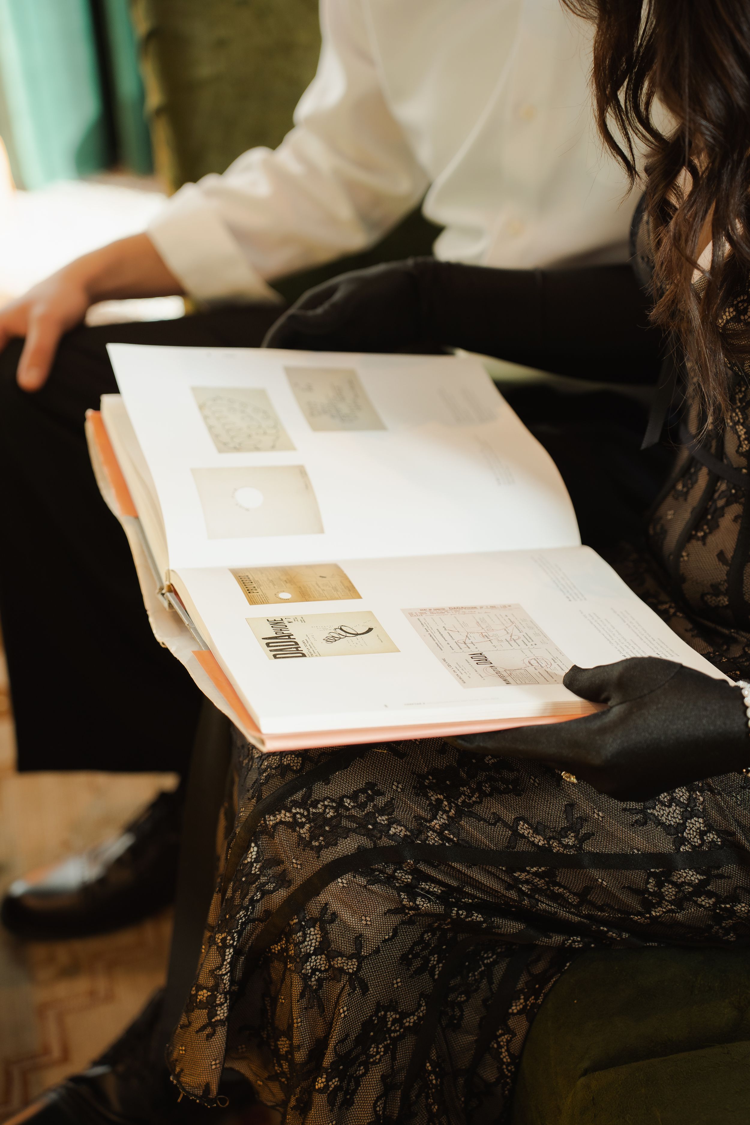 Multiple sequential images show hands holding open pages of a book with text and photographs.