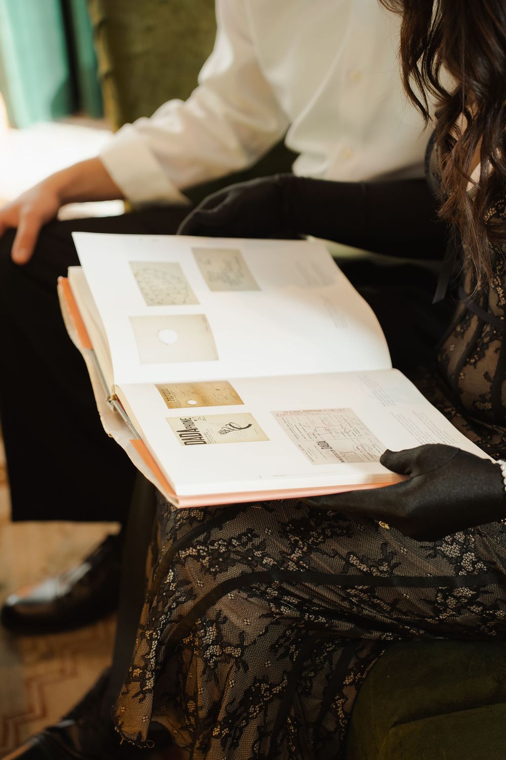Multiple sequential images show hands holding open pages of a book with text and photographs.