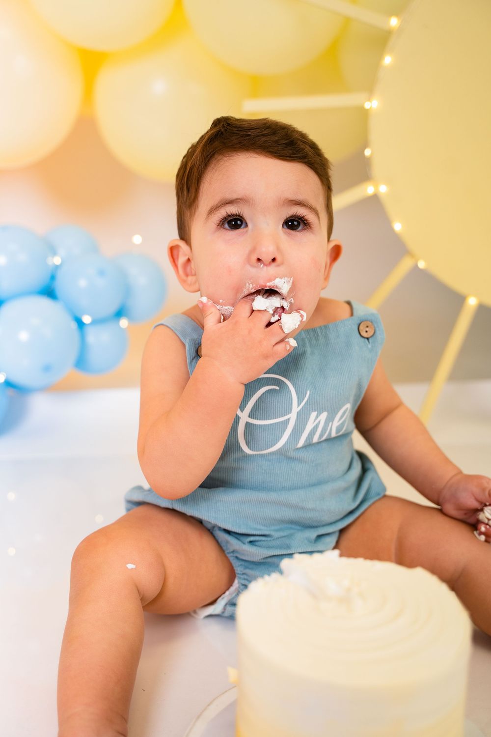 Baby boy cake smash photoshoot in New Jersey celebrating first birthday in studio