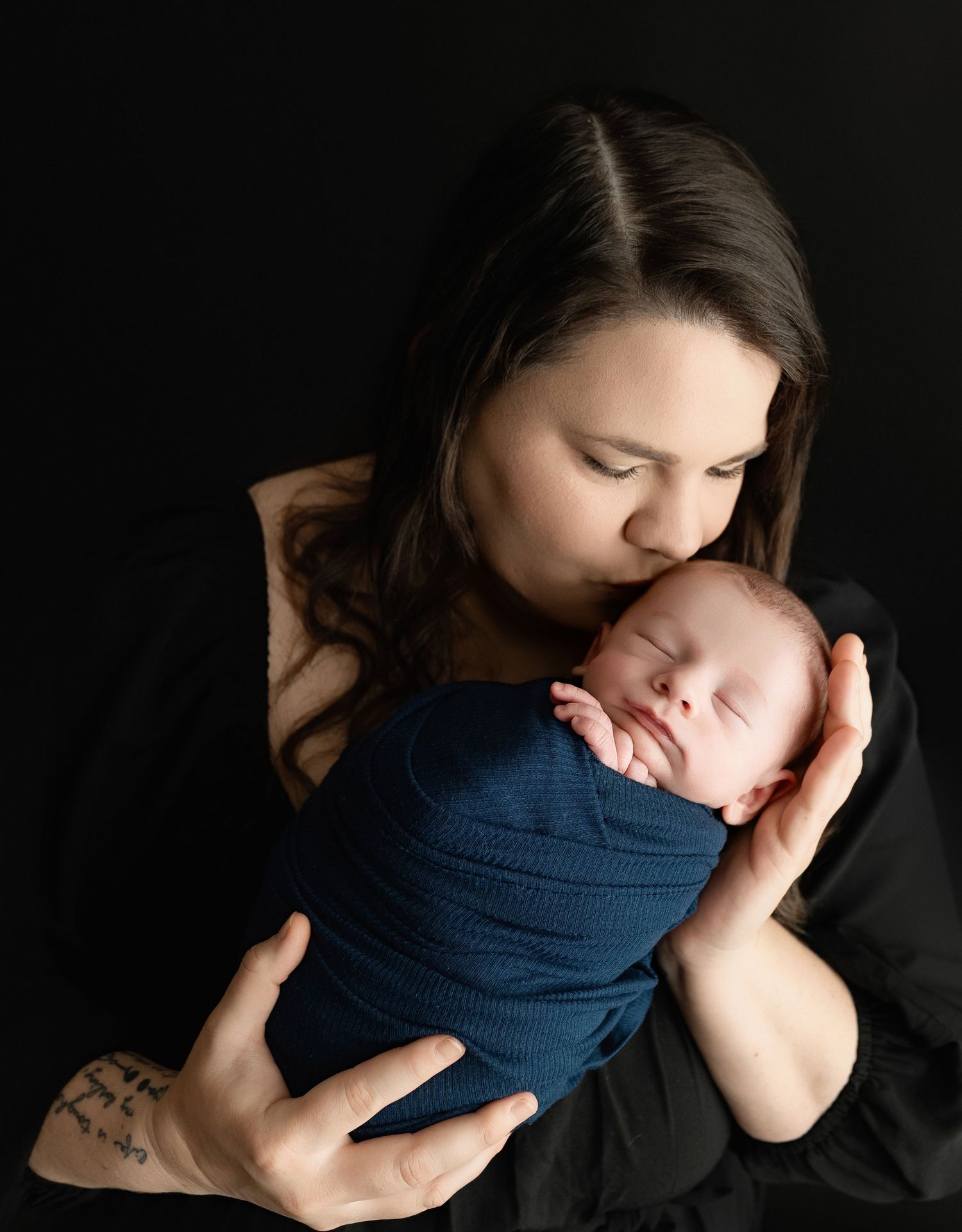 A mom kissing a newborn boy's head. Greenville, SC newborn photographer, Easley SC newborn photographer, Upstate SC newborn photographer