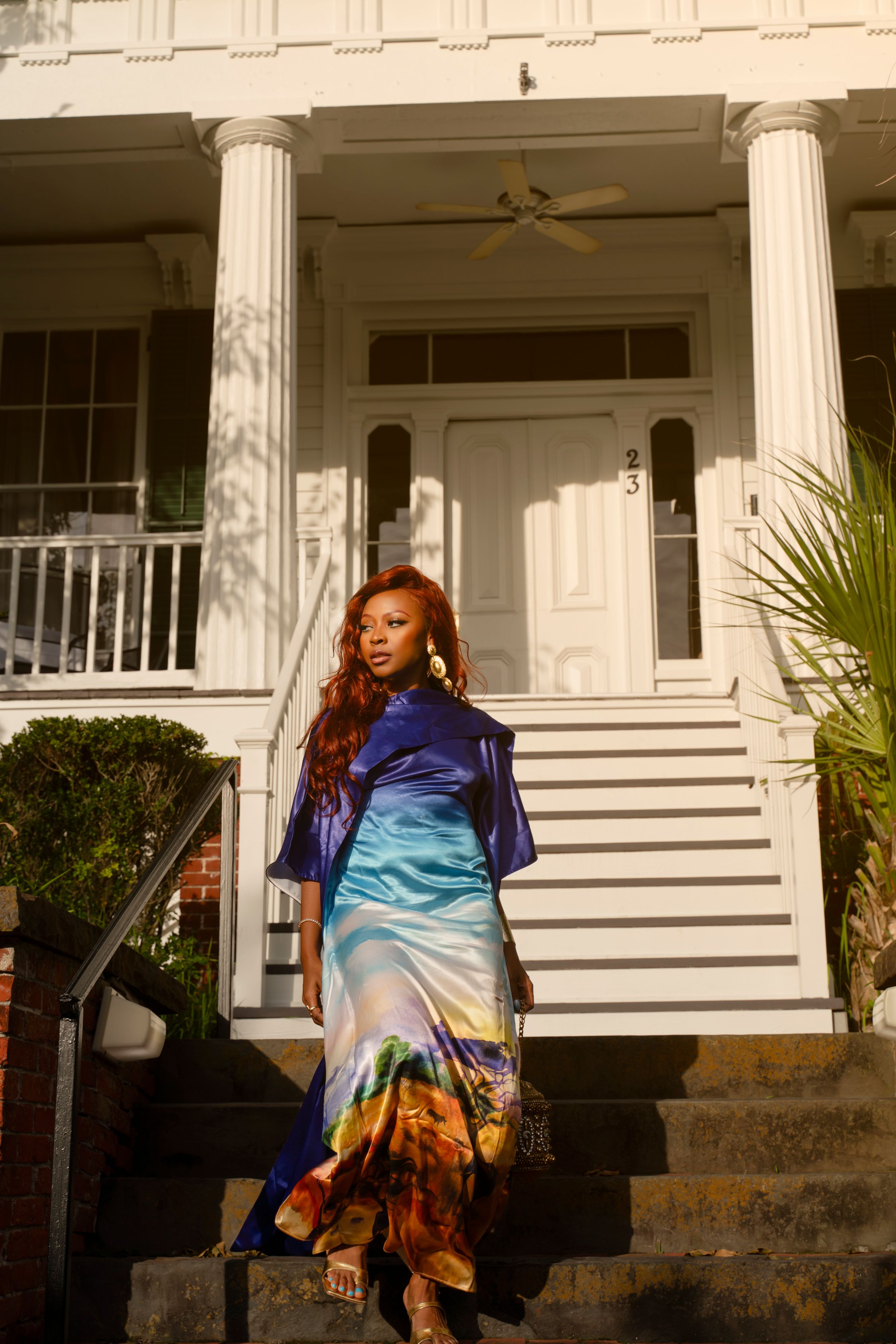 A series of photos showing someone in colorful tie-dye clothing sitting on white porch steps of a traditional house.