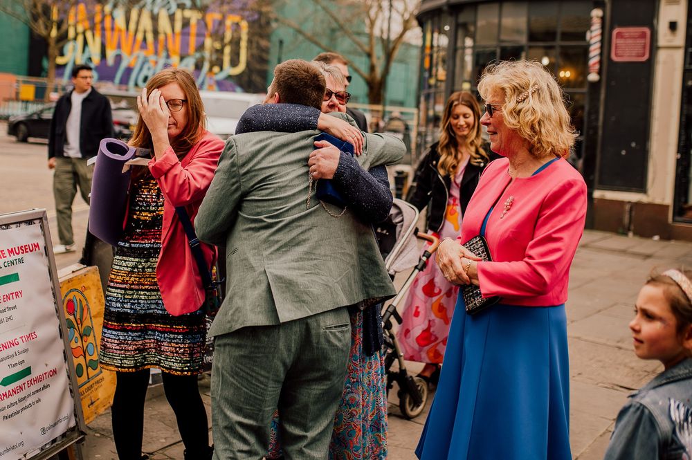 Couples dancing together in a social gathering on a city street with festive atmosphere.