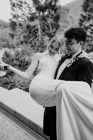 A series of candid wedding moments captured in black and white showing the couple laughing and embracing.