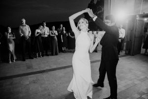 Black and white photos show a couple dancing together at a wedding reception with guests watching.