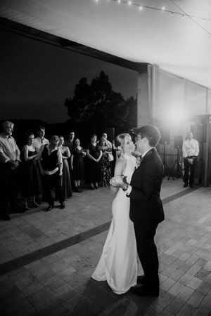 Black and white photo series of couples dancing during a romantic first dance at an indoor wedding reception.