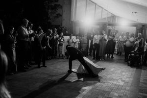A series of black and white dance floor photos showing silhouettes of people dancing at a wedding reception.