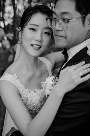 A romantic black and white photo sequence showing a couple in wedding attire sharing intimate moments together.