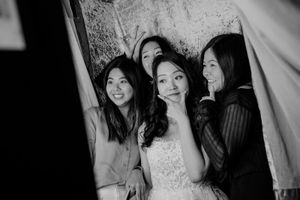 A series of black and white wedding photos showing candid moments and celebrations between couples and guests.
