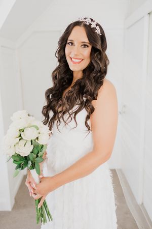 Beautiful bridal portrait series showing white wedding dress, floral bouquet and delicate crystal hair accessories.