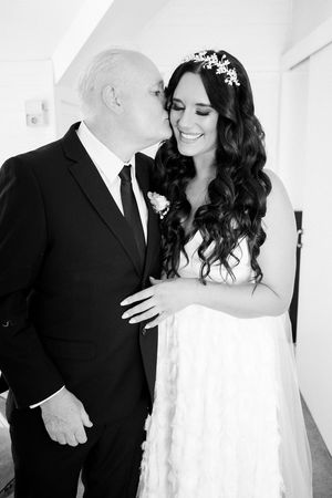 Black and white wedding photos show tender moments between newlyweds in a romantic series.