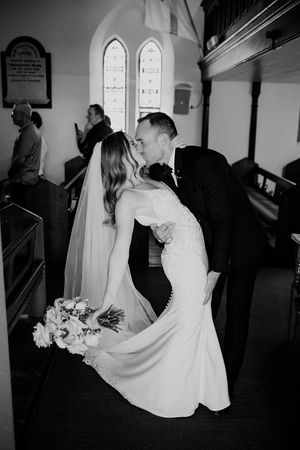A black and white photo sequence showing a bride in a white dress walking down a church aisle.