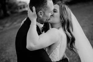 Black and white collage of romantic wedding moments showing embraces and kisses between newlyweds.