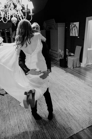 Black and white photo series showing a couple dancing together in an intimate moment on a textured floor.