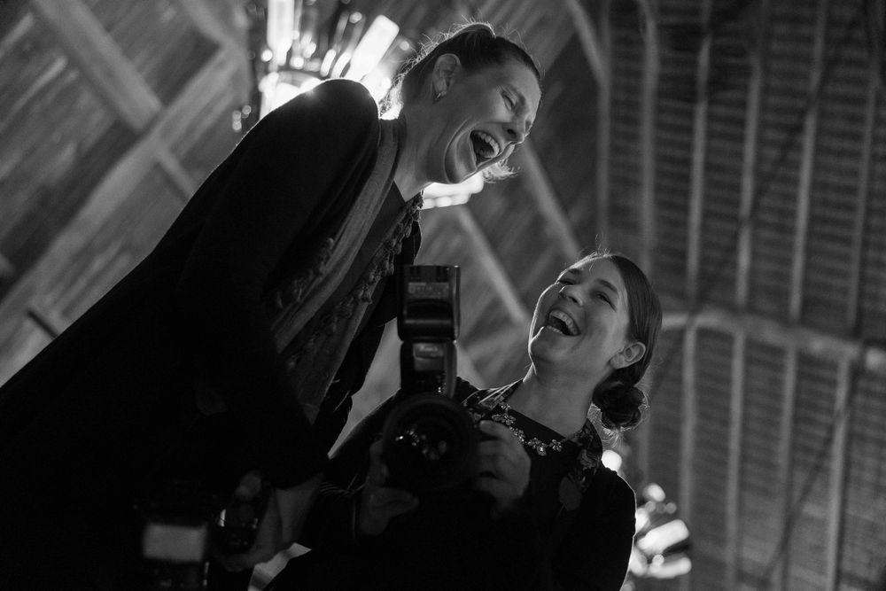 A series of black and white photographs showing people laughing and expressing joy in candid moments.