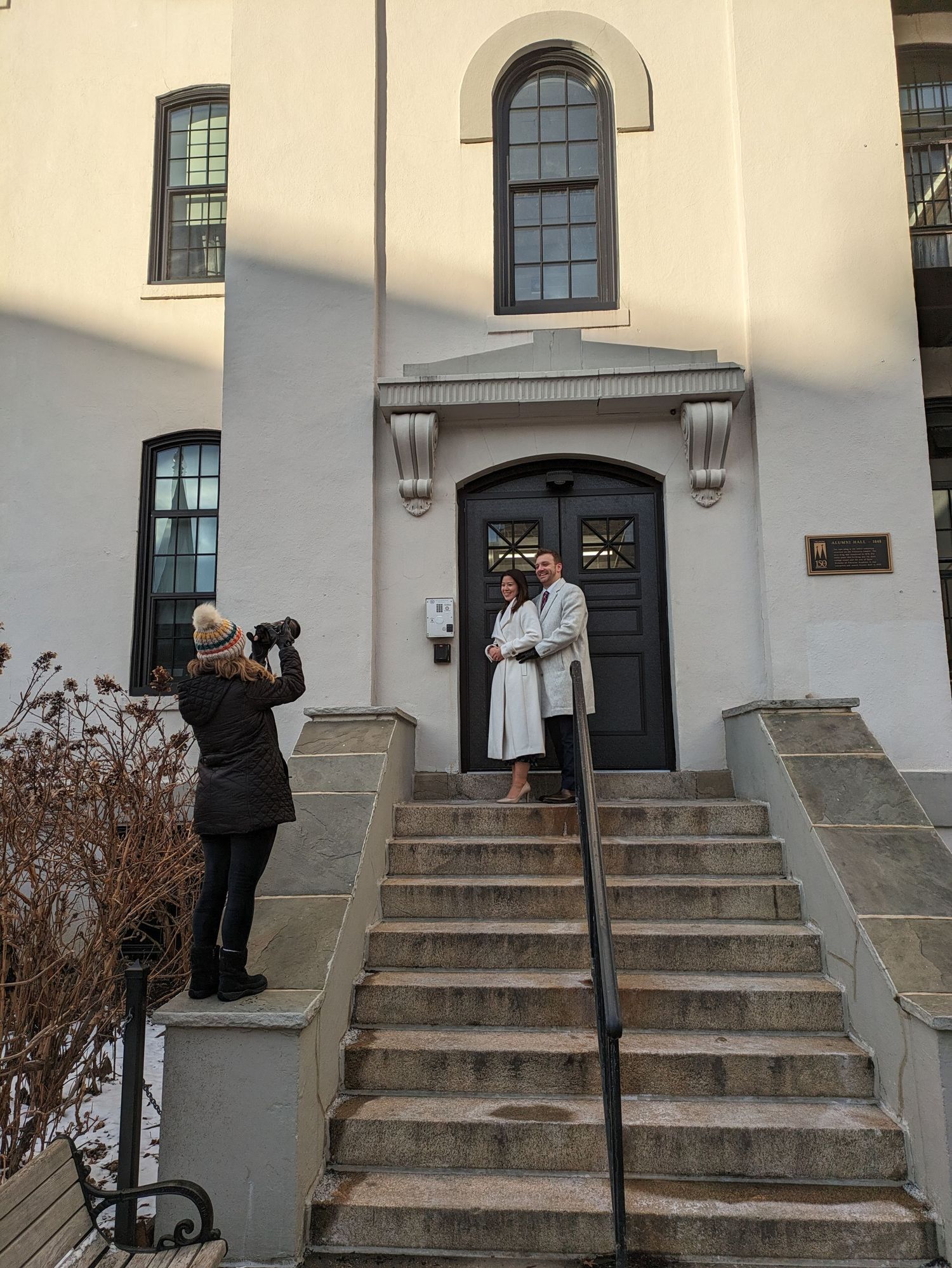 A sequence of five photos showing someone walking up concrete steps in front of a white building entrance.