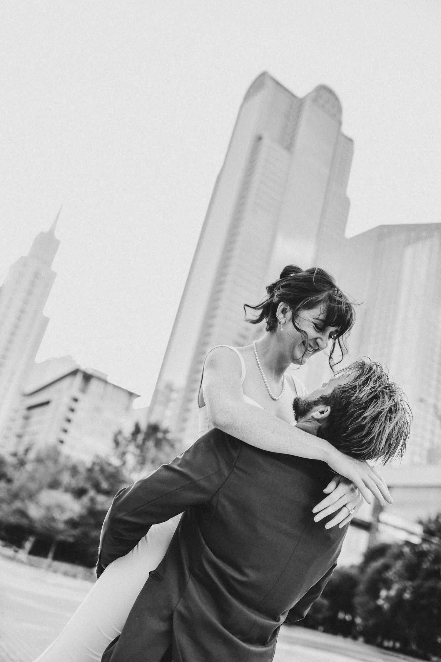 Romantic engagement photos of couple walking through Downtown Dallas Historic District