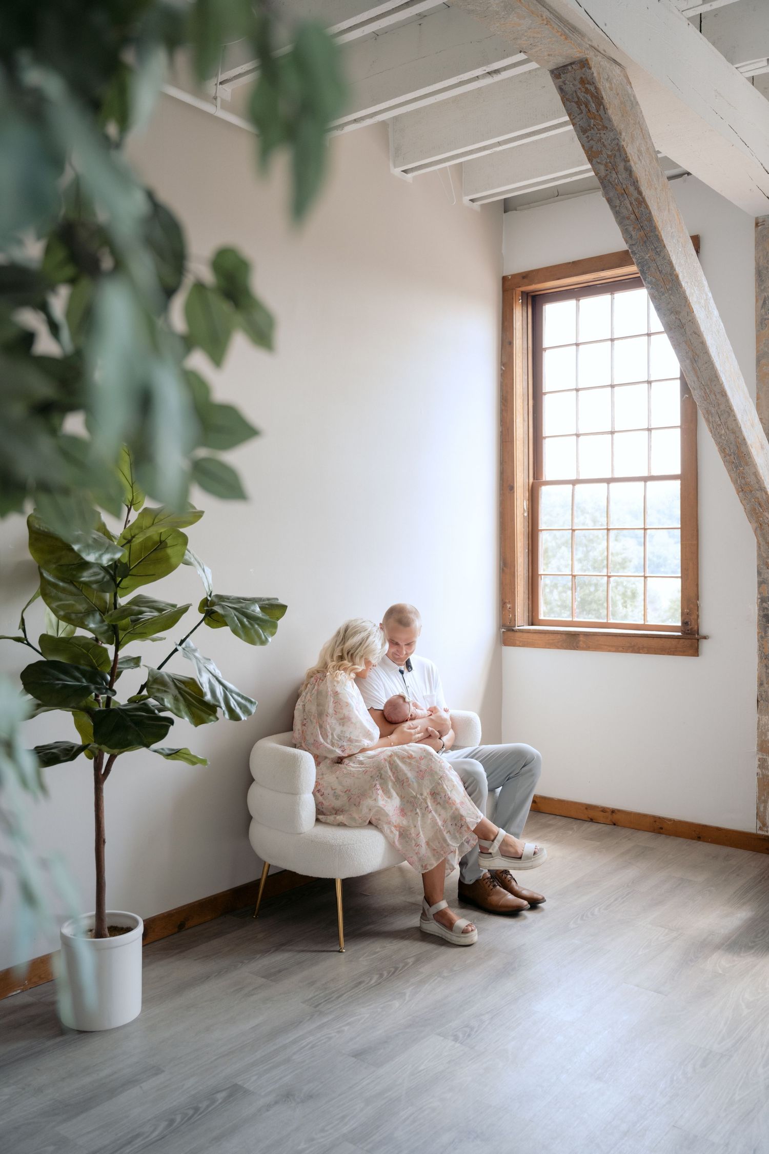 candid photo of parents admiring newborn baby during in studio lifestyle newborn session in stillwater, mn at The Hive House studio.