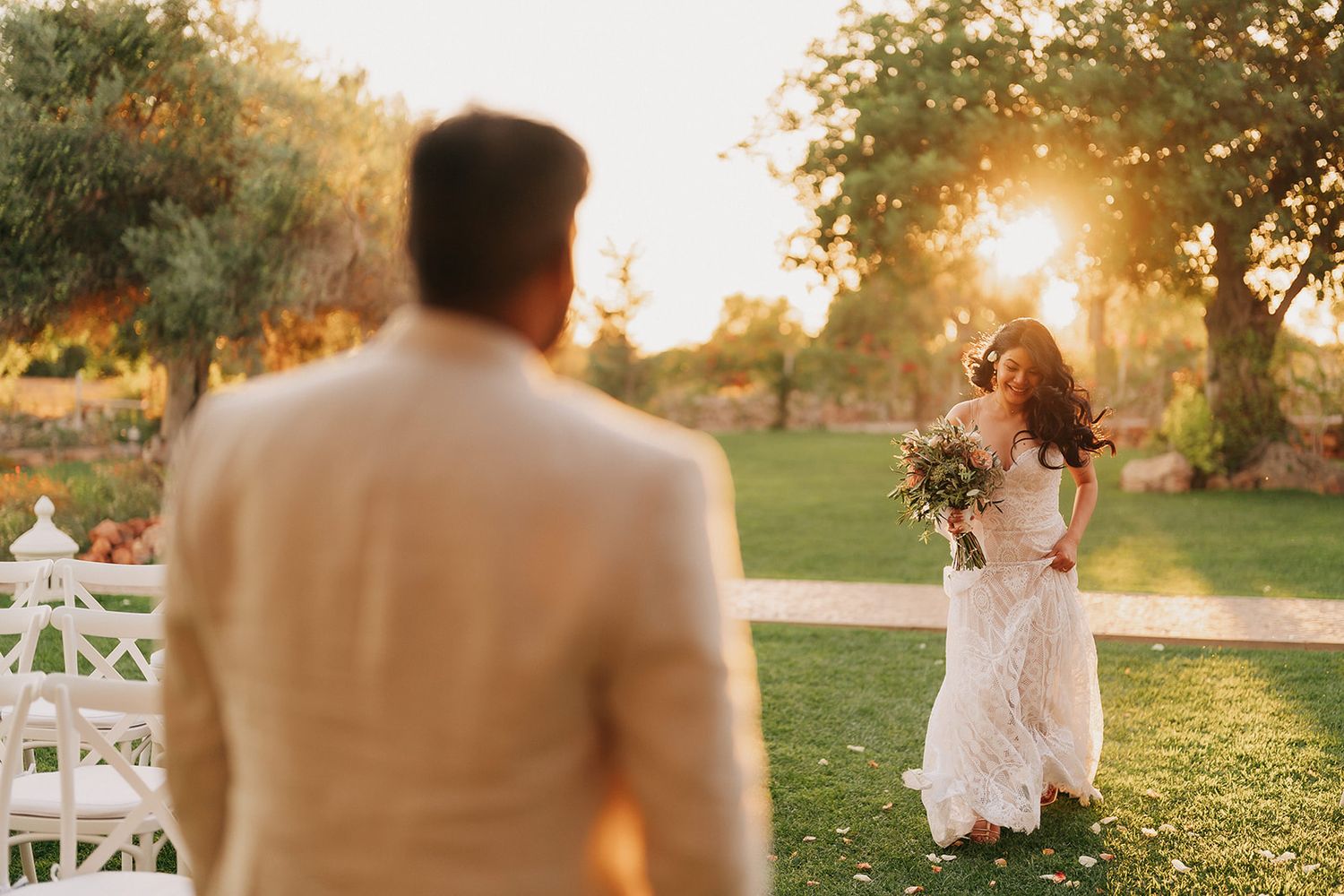 Golden hour wedding photography in outdoor garden setting with white decor.