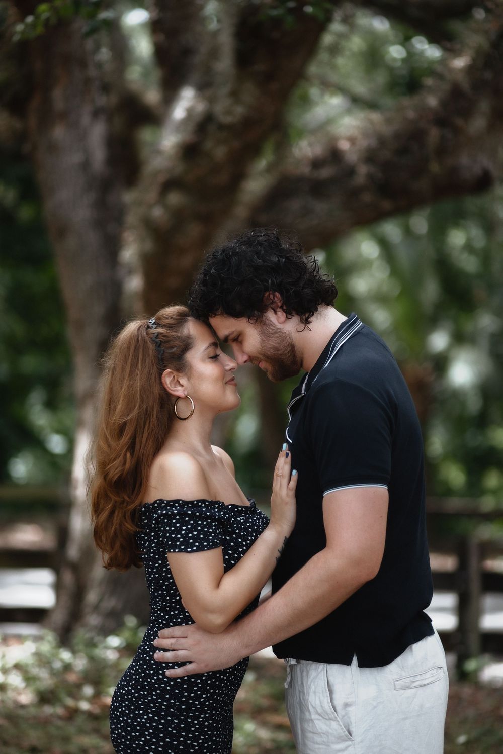 Couple kissing at Kendall Indian Hammocks Park Miami during engagement couples session.