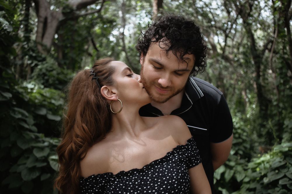 Couple kissing at Kendall Indian Hammocks Park Miami during engagement couples session.