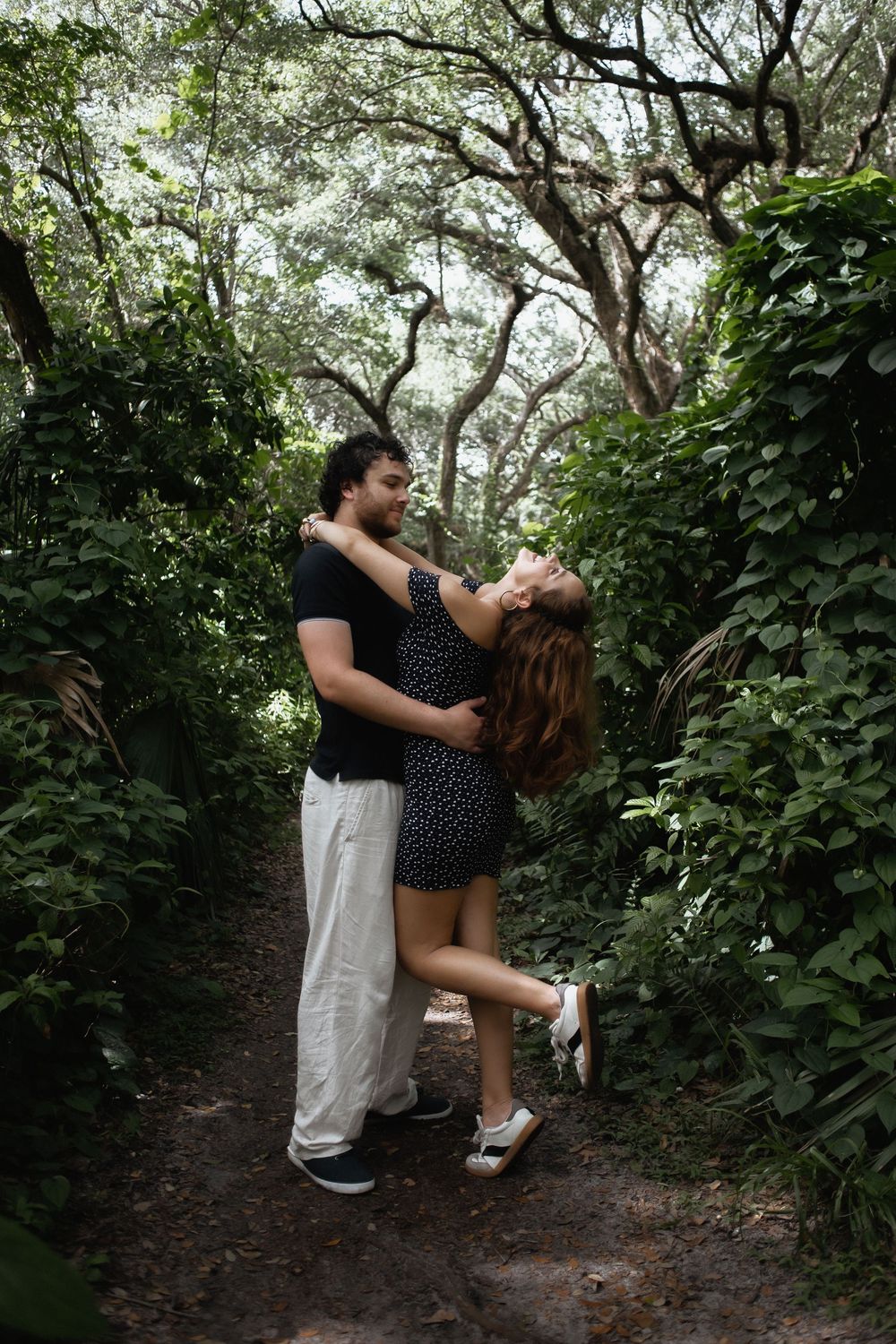 Couple embracing at Kendall Indian Hammocks Park Miami during engagement couples session.