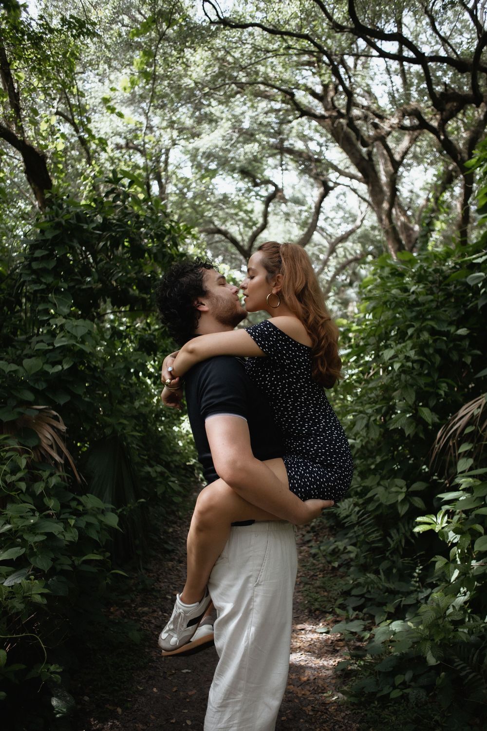 Couple embracing at Kendall Indian Hammocks Park Miami during engagement couples session.