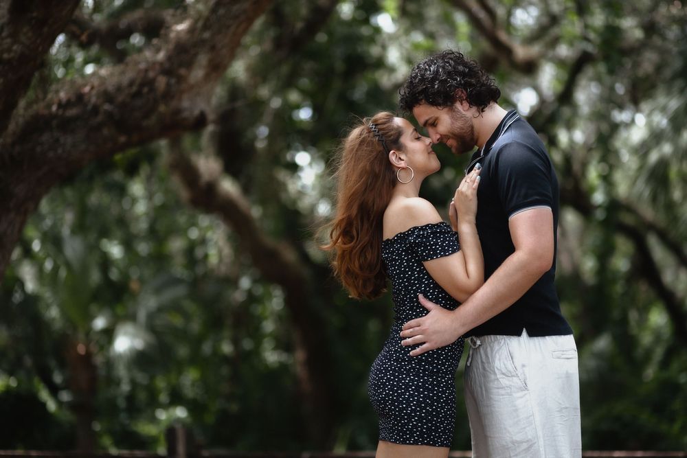 Couple kissing at Kendall Indian Hammocks Park Miami during engagement couples session.