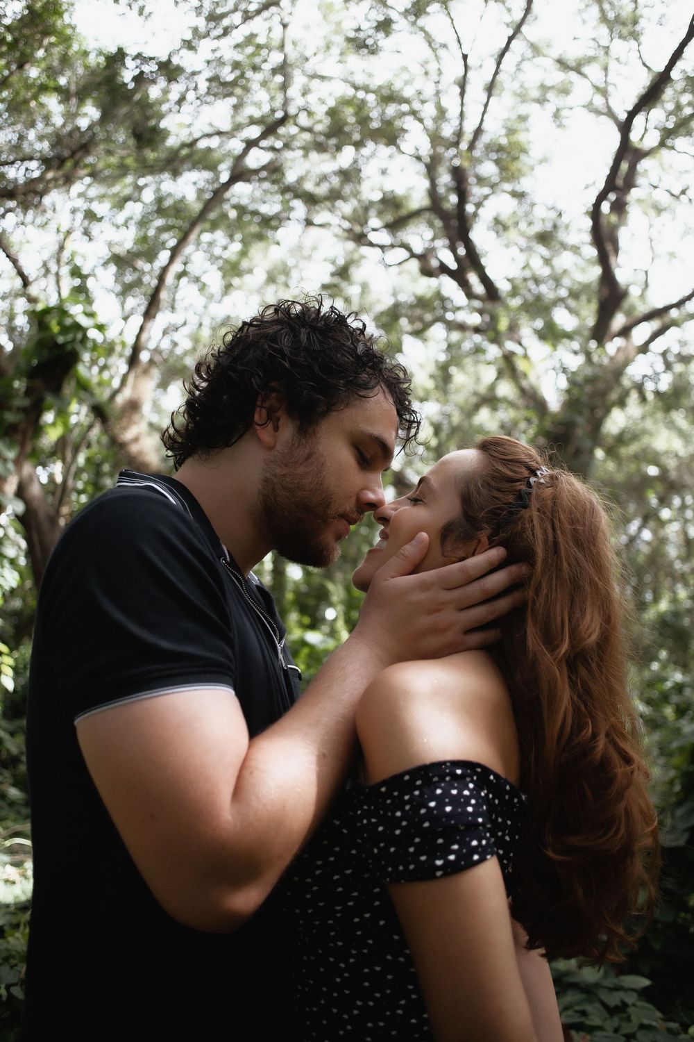 Couple kissing at Kendall Indian Hammocks Park Miami during engagement couples session.
