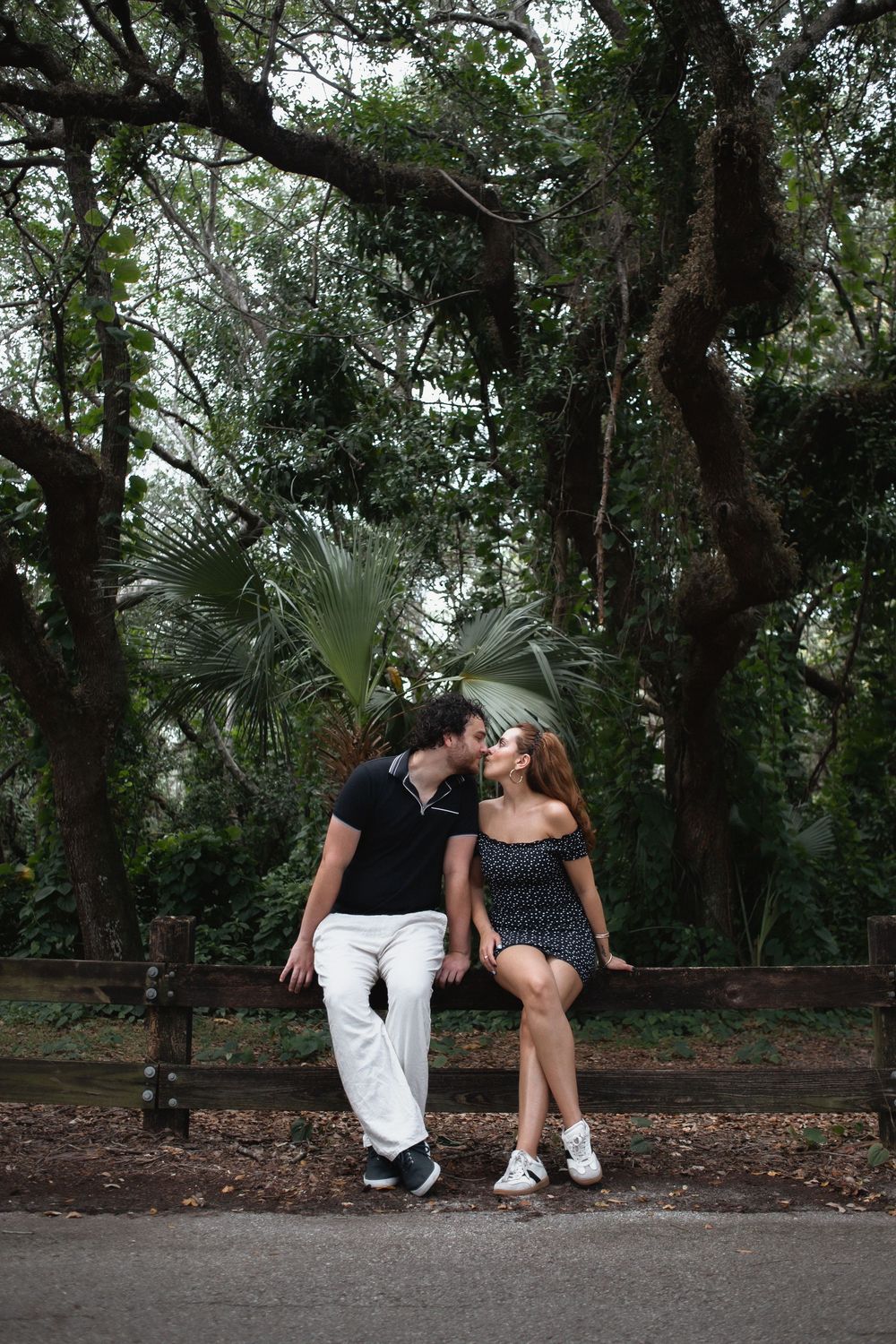 Couple kissing at Kendall Indian Hammocks Park Miami during engagement couples session.