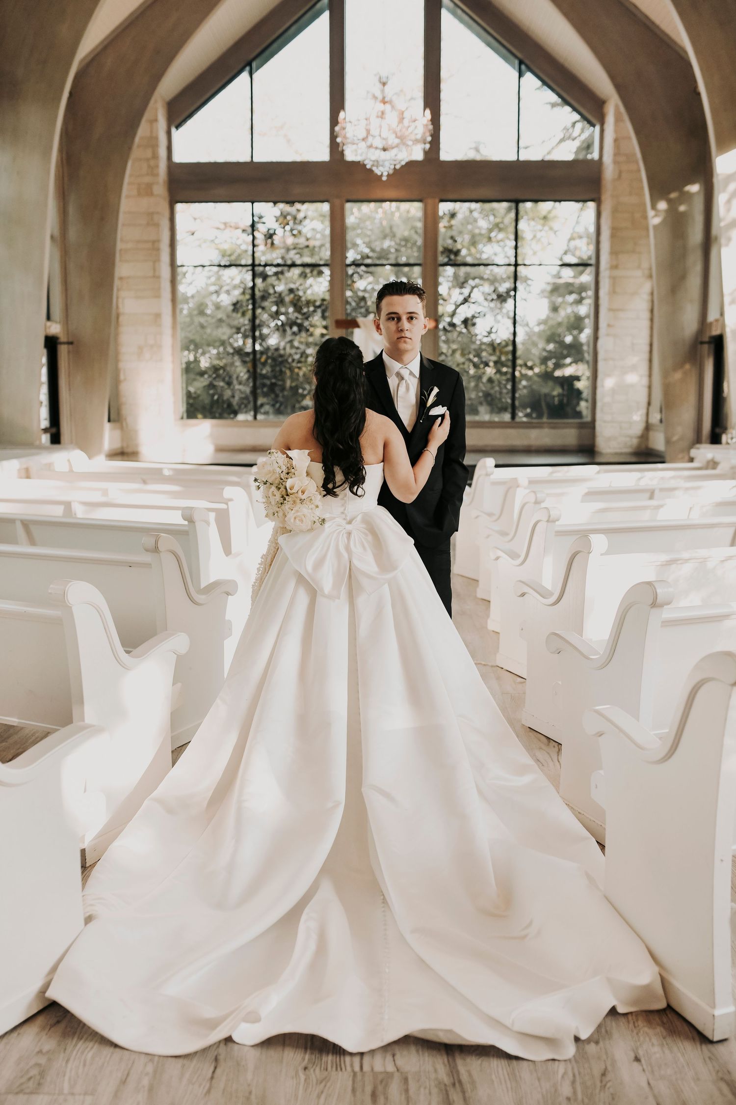 Elegant black tie wedding portrait featuring natural light
