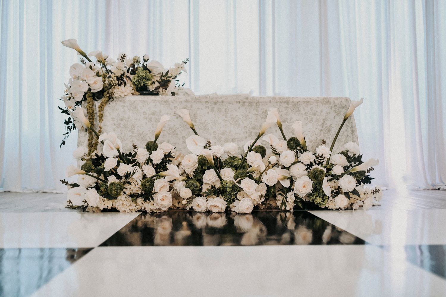 Reception tables decorated with elegant black bows and florals