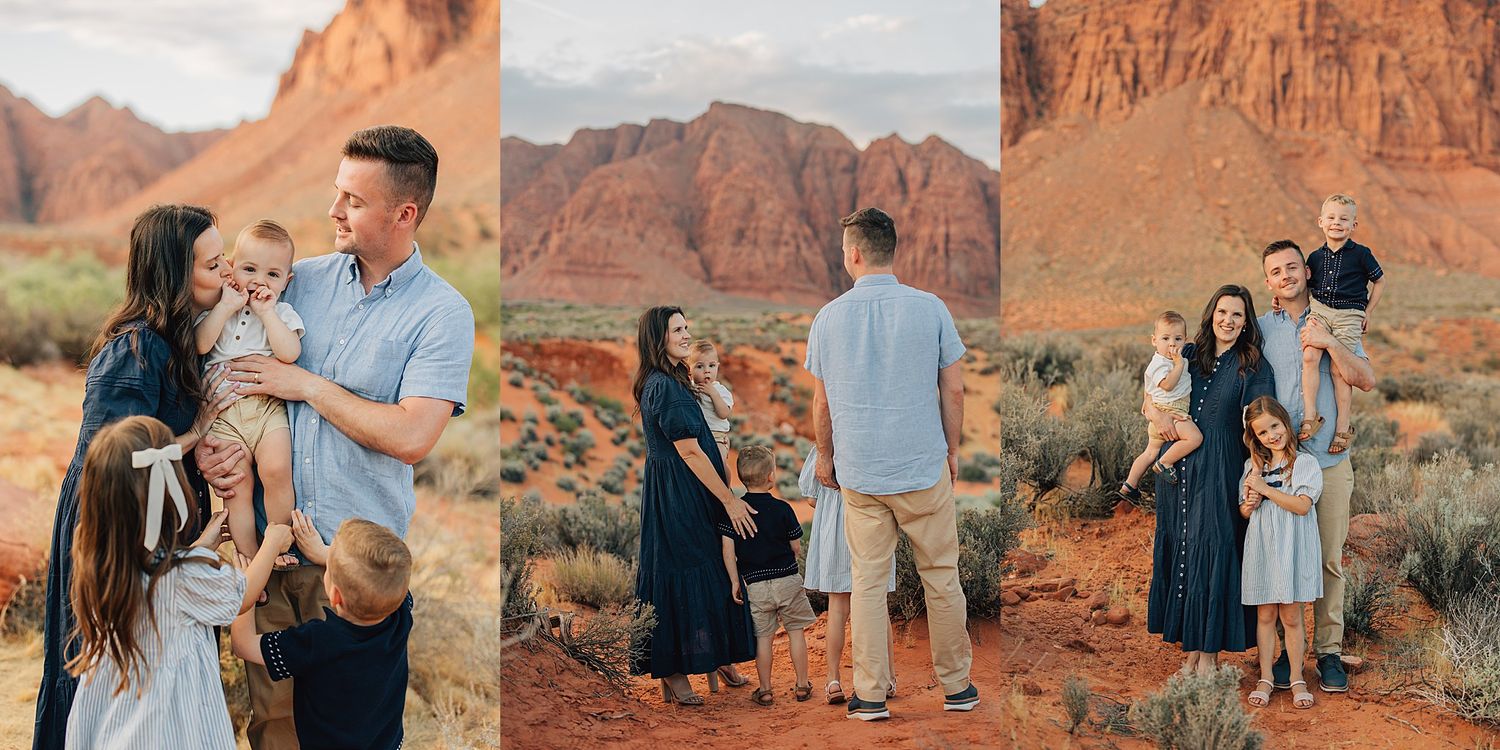 Family posing in red desert landscape with sandstone cliffs, wearing coordinated outfits of blue and white, during golden hour.