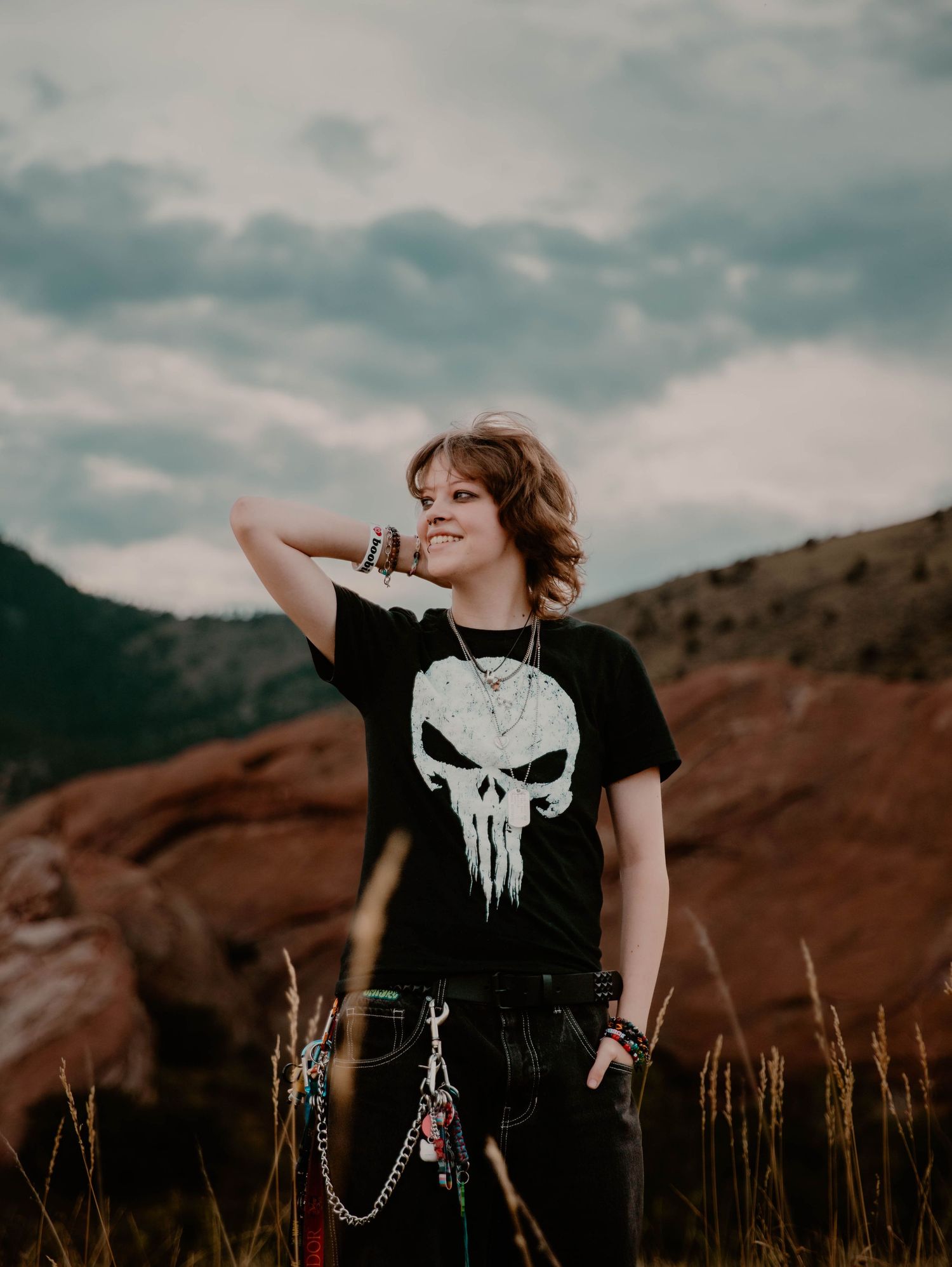 Boy stands, smiles, and poses for senior photos, cinematic, mountain, portrait photos in Morrison, Colorado outside and in nature