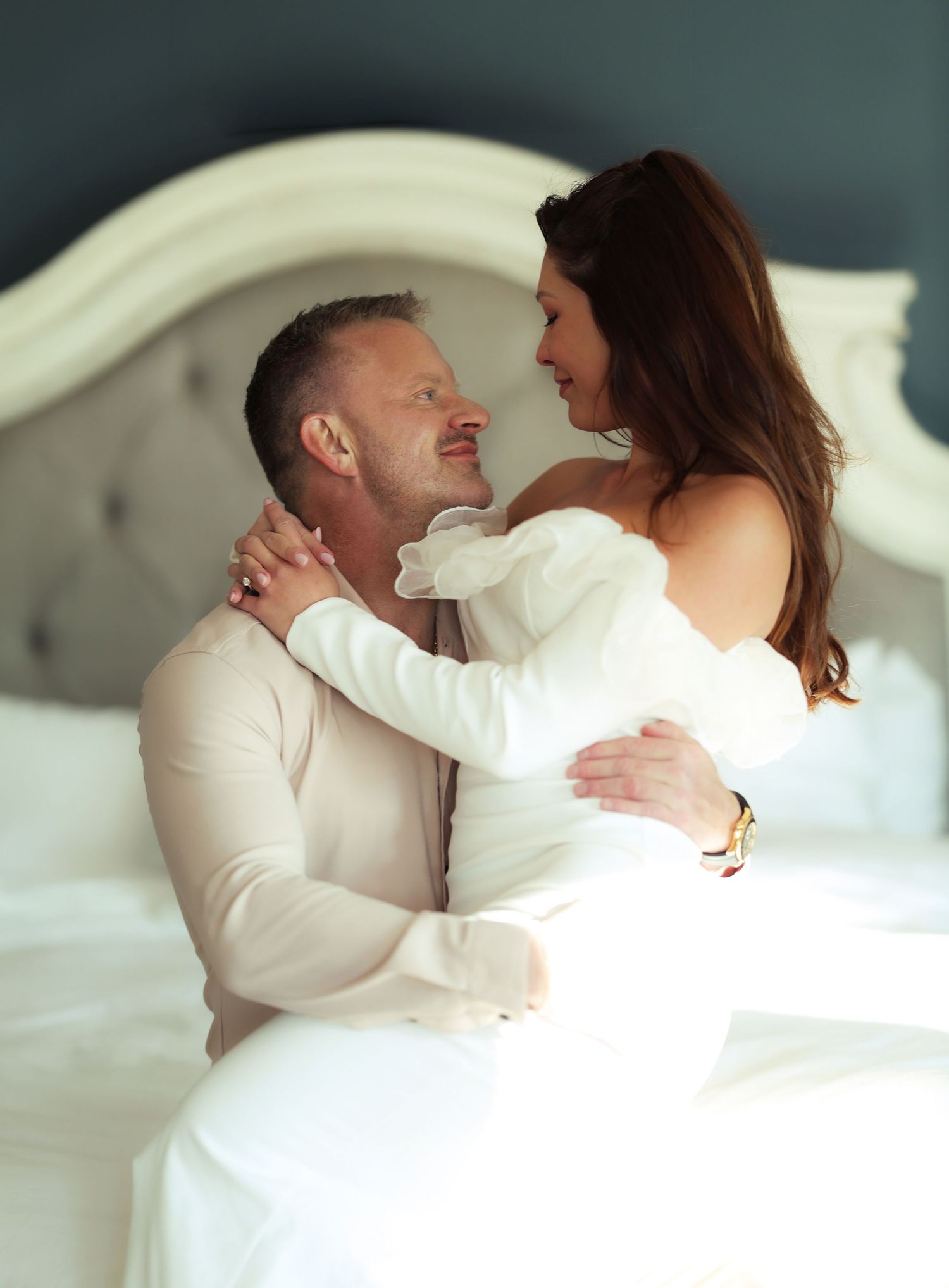 a happy couple posing for photographer during an engagement session