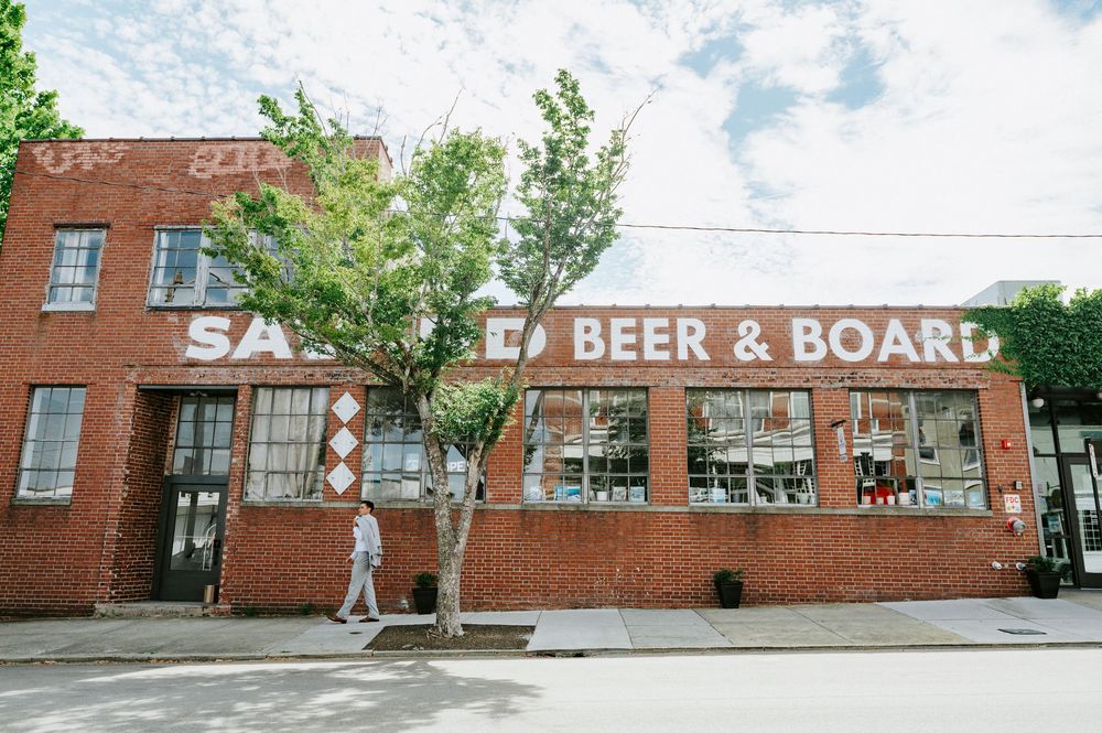 Exterior of a brick building housing Sauced Beer and Board restaurant.