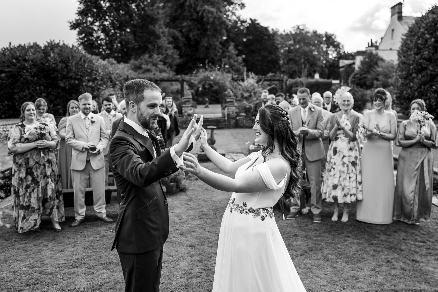 non-traditional wedding photographer in the Lake District - black and white  ceremony  holding hands