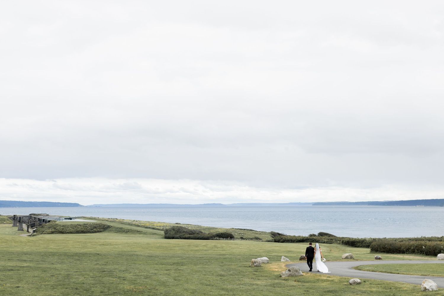 Rolling green hills and coastal landscape stretch towards a cloudy horizon on a Washington island.