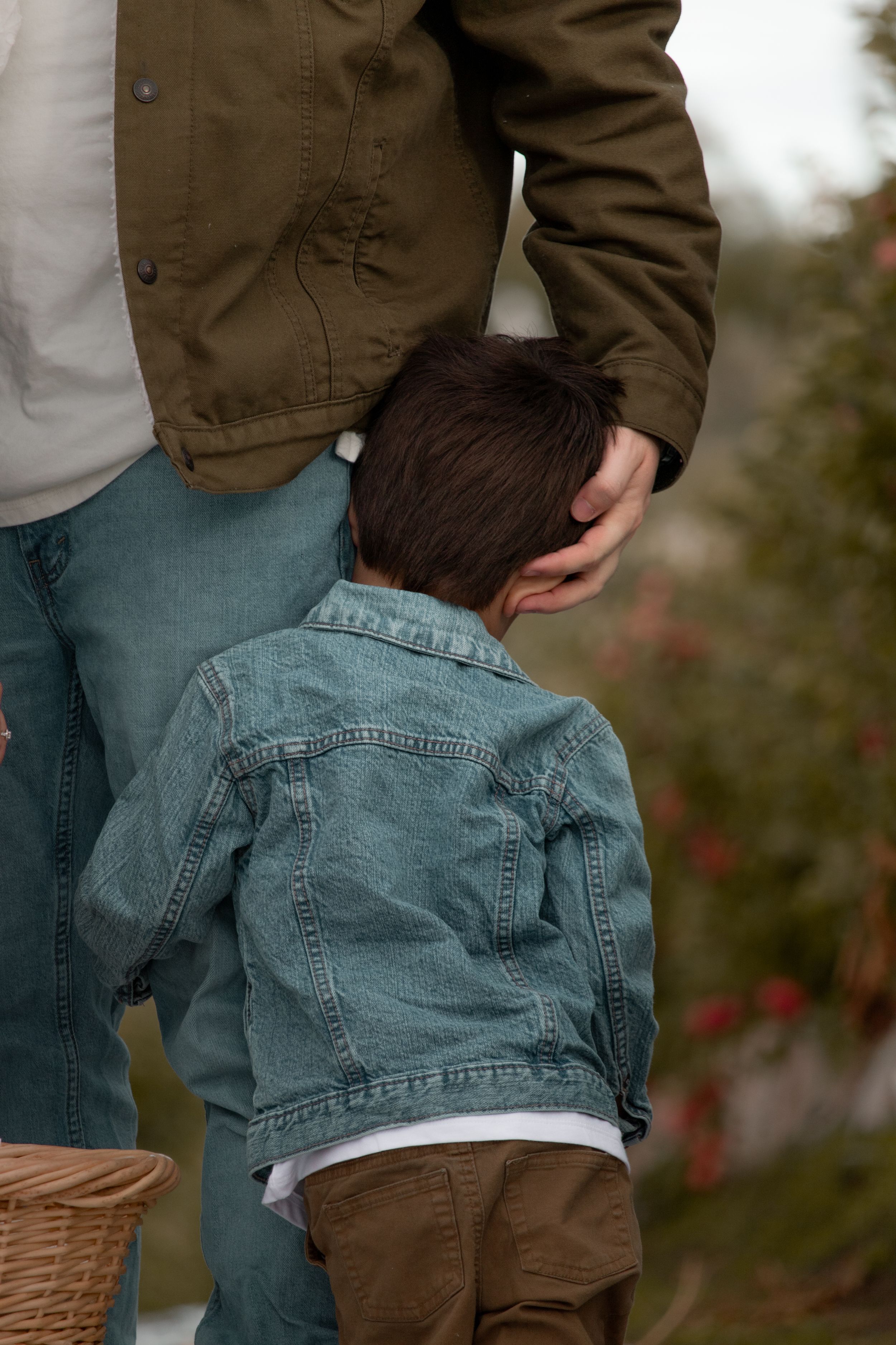Young Child hugging his dad during a family photoshoot in Eastern WA