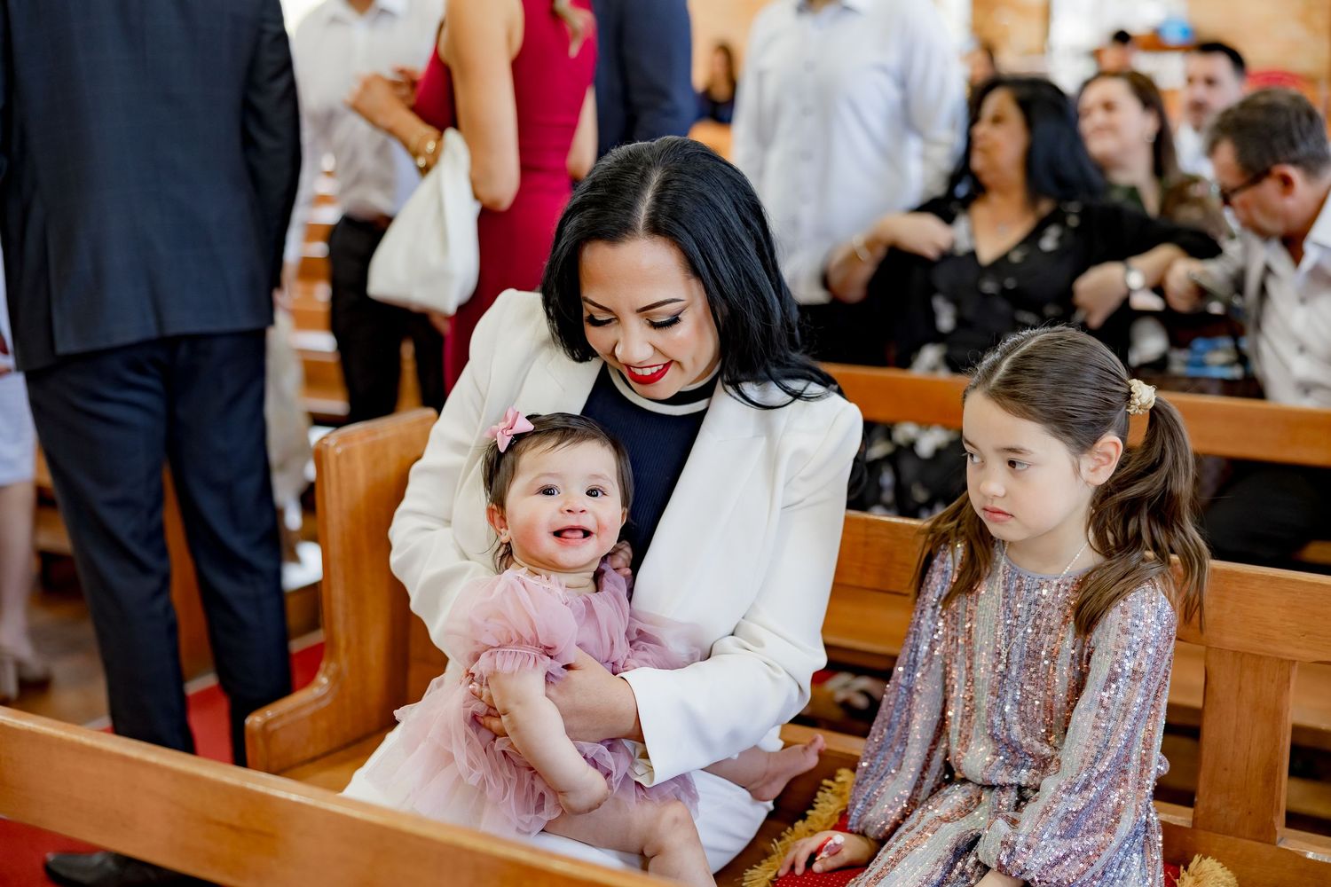 Joyful moment during a christening ceremony in church pews.