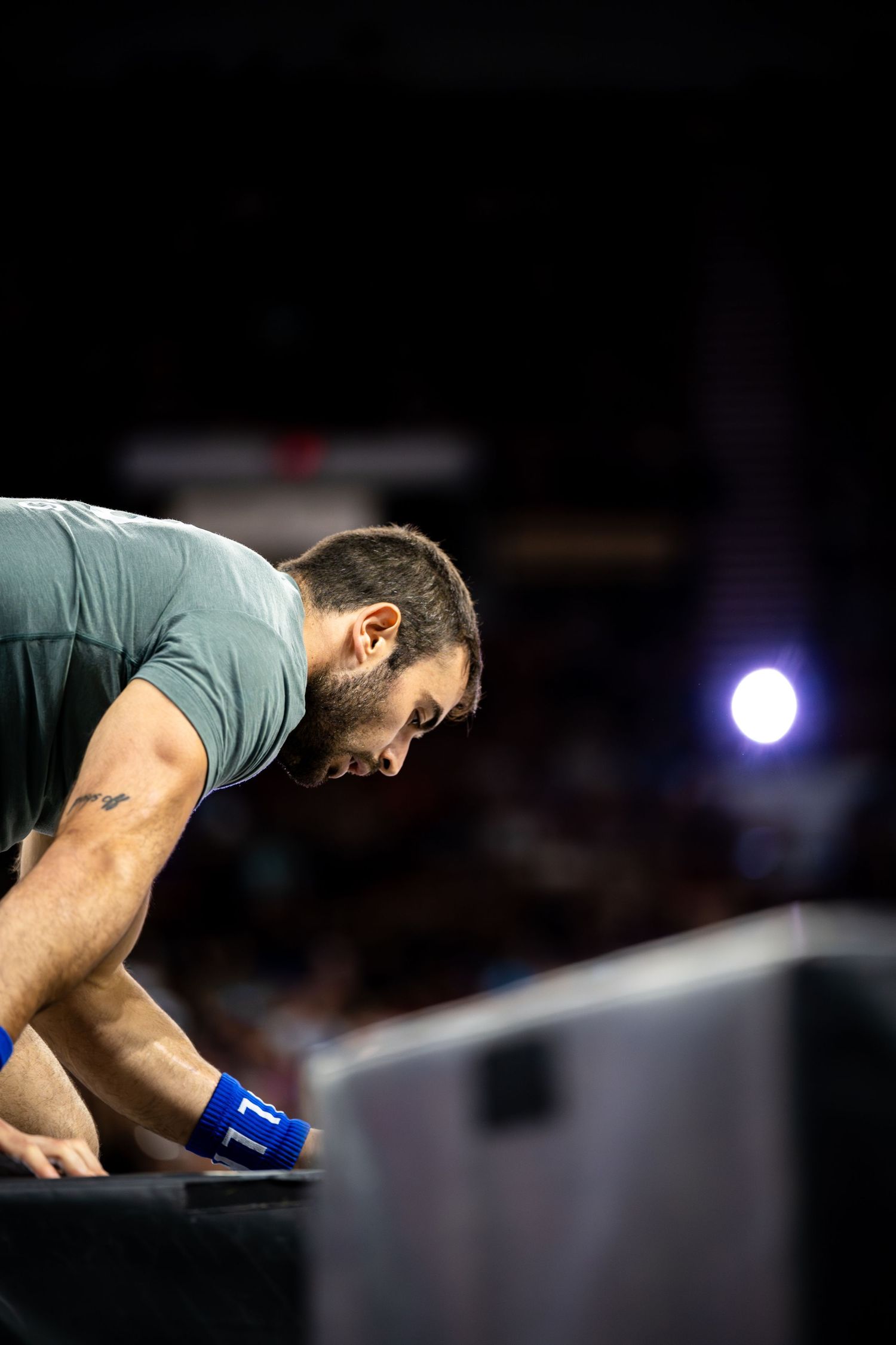 CrossFit athlete focusing intensely during competition workout.