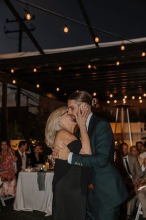 Couples sharing romantic moments on the dance floor under ambient lighting.