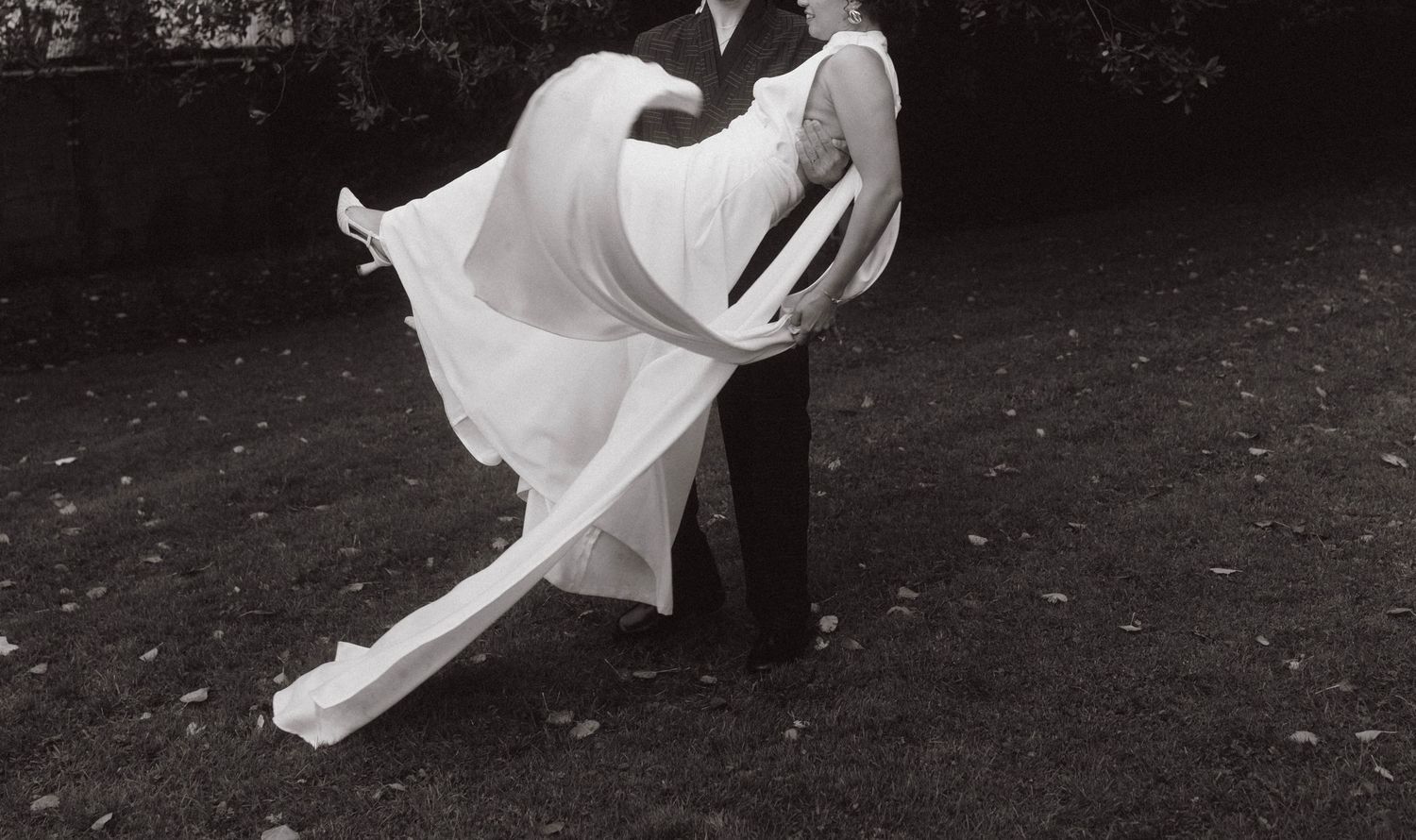 A romantic black and white wedding portrait showing a tender moment between a couple.